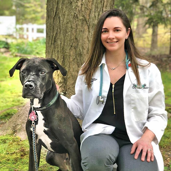 Veterinarian posing with a dog
