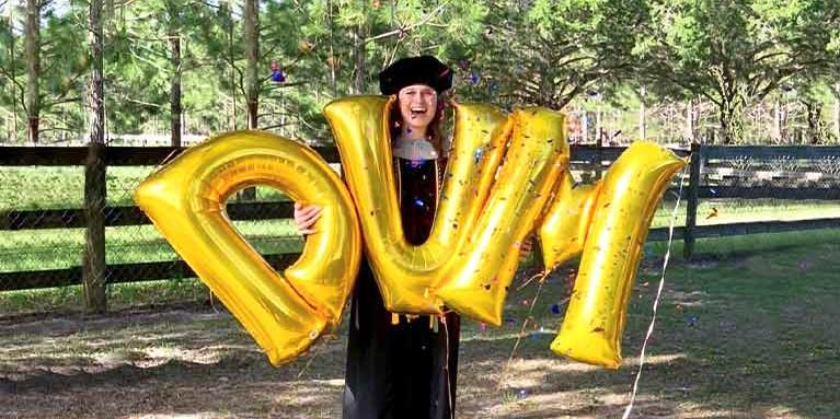 Graduate Celebrating with DVM balloons