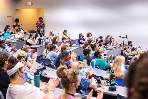 A group of students listening to a speaker at Research Week 2021