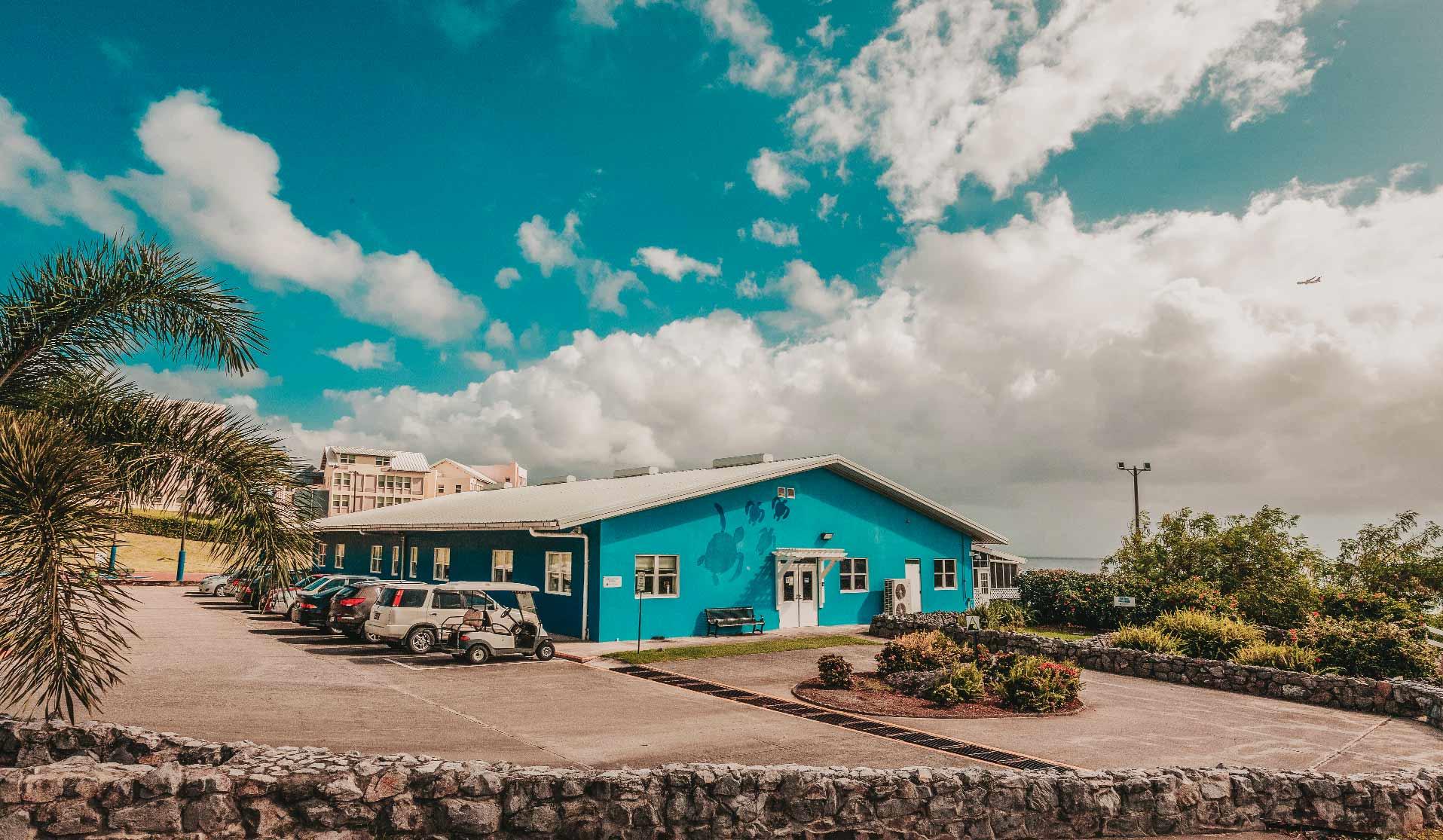 A blue Ross Vet building with cars parked in front
