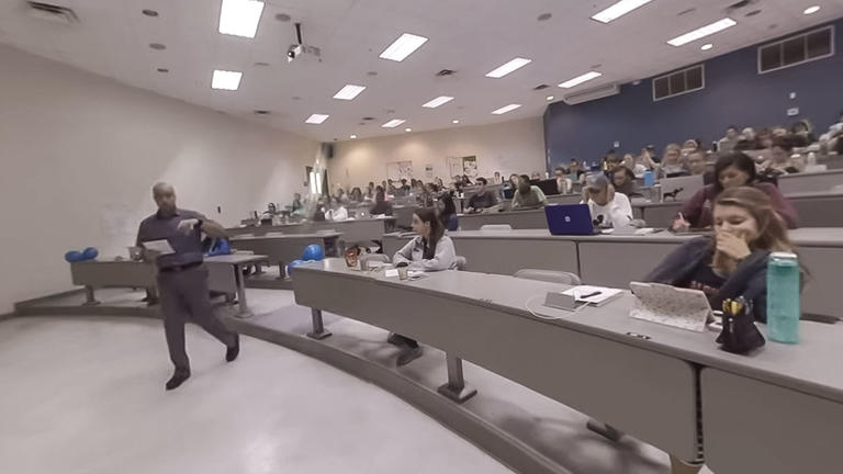 Professor presenting to Ross students in a large classroom