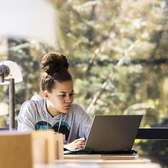 Ross Vet student studying on her laptop