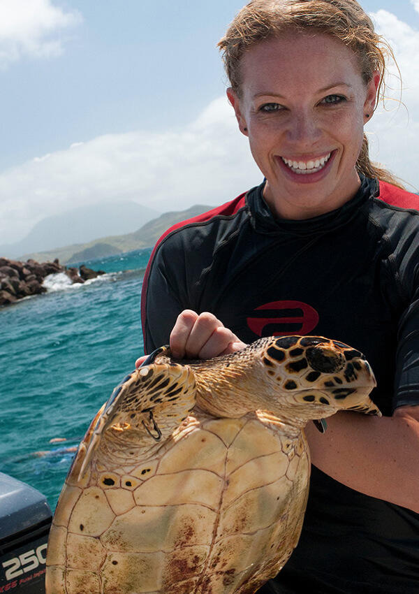 Woman holding a turtle