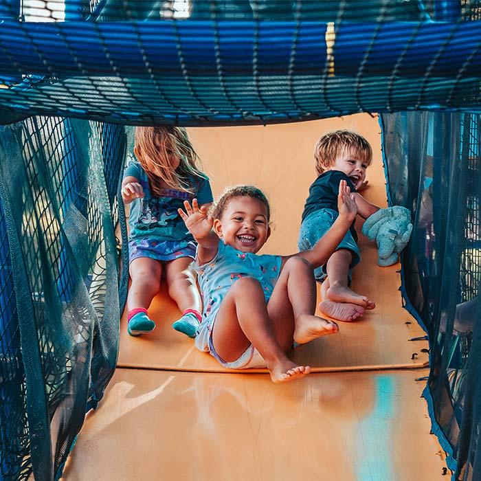 Three children playing on a playground