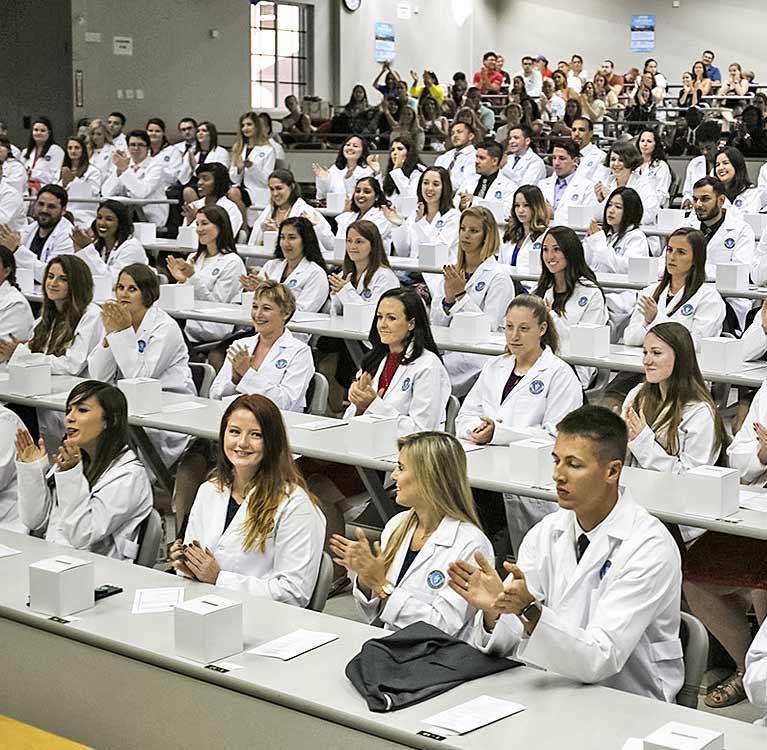 Students in white coats in classroom