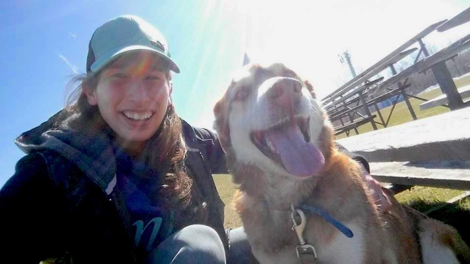 Student and dog selfie outside