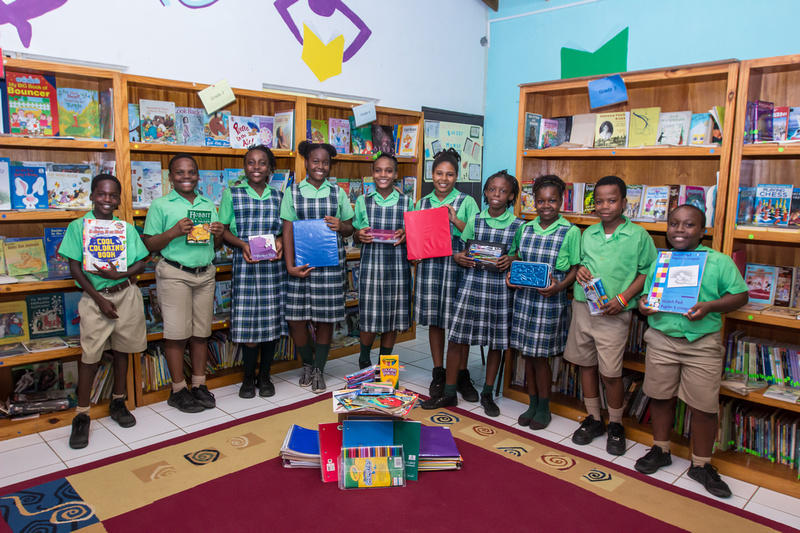 Primary students in a library holding books