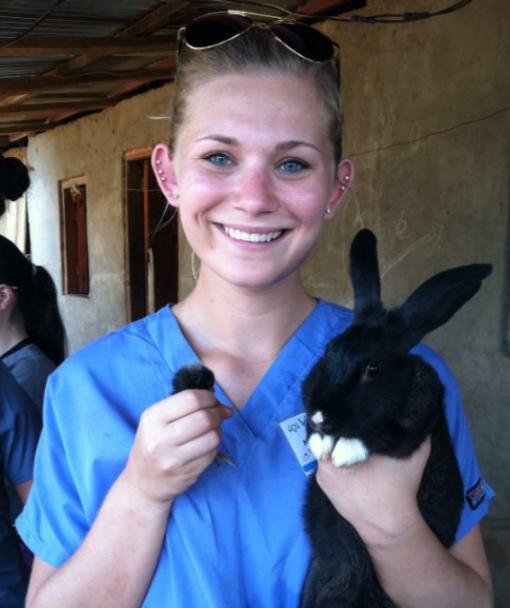Student posing holding a rabbit